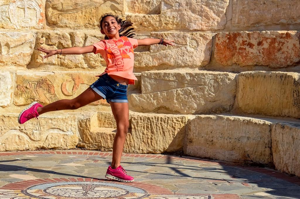 Outdoor amphitheater surrounded by lush gardens at sunset